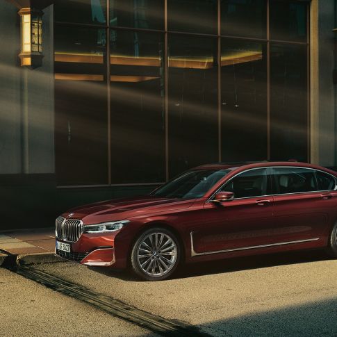 BMW Individual 7 Series Sedan, side view BMW Individual 7 Series Sedan in red in side view in front of urban setting