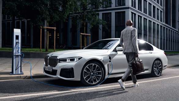 BMW 7 Series Sedan plug-in hybrid G11 G12 three-quarter side view charging BMW 7 Series Sedan plug-in hybrid G11 G12 three-quarter side view charging with model