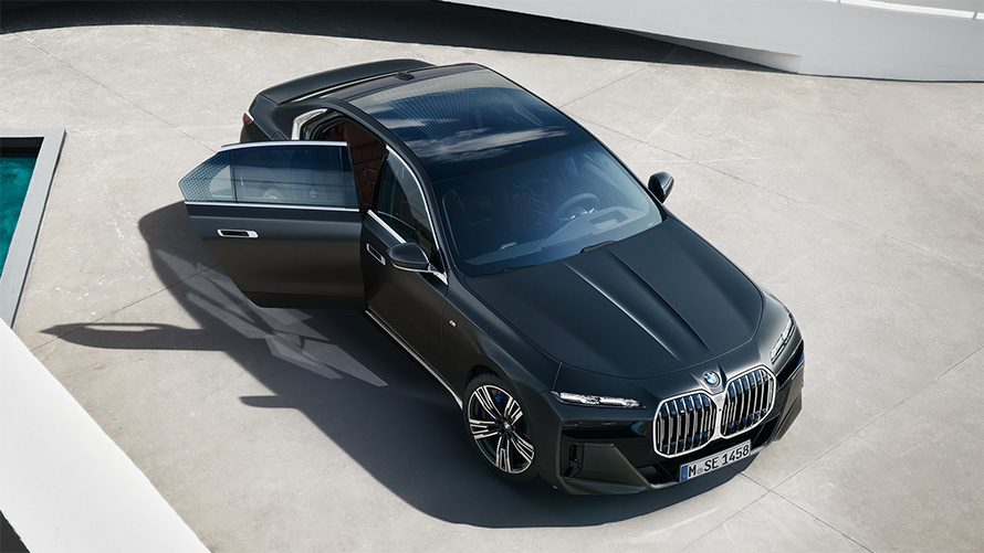 BMW 7 Series Sedan G70 ICE 740i M sports package Frozen Deep Grey metallic bird's eye view with open passenger door