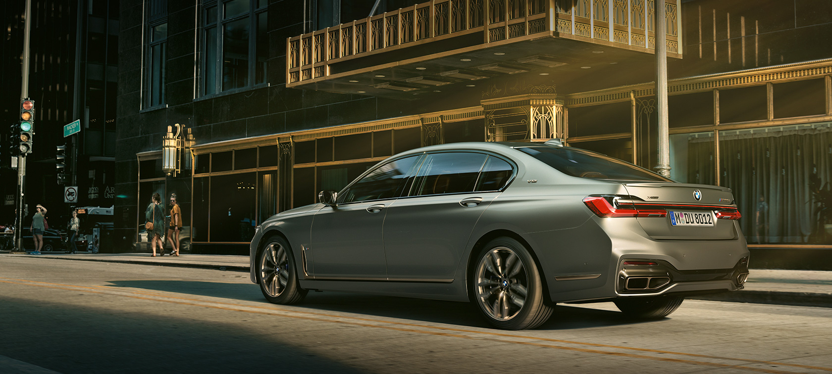 BMW M760Li xDrive Sedan 2019 G11 G12 lateral rear view in front of skyscrapers in urban setting