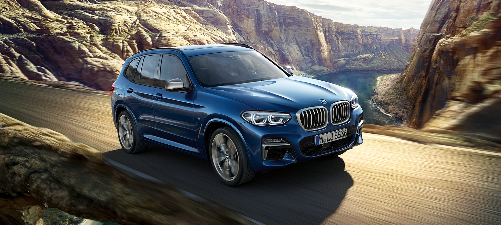 BMW X3 M40i, driving shot in front of canyon BMW X3 M40i, driving shot in front of canyon